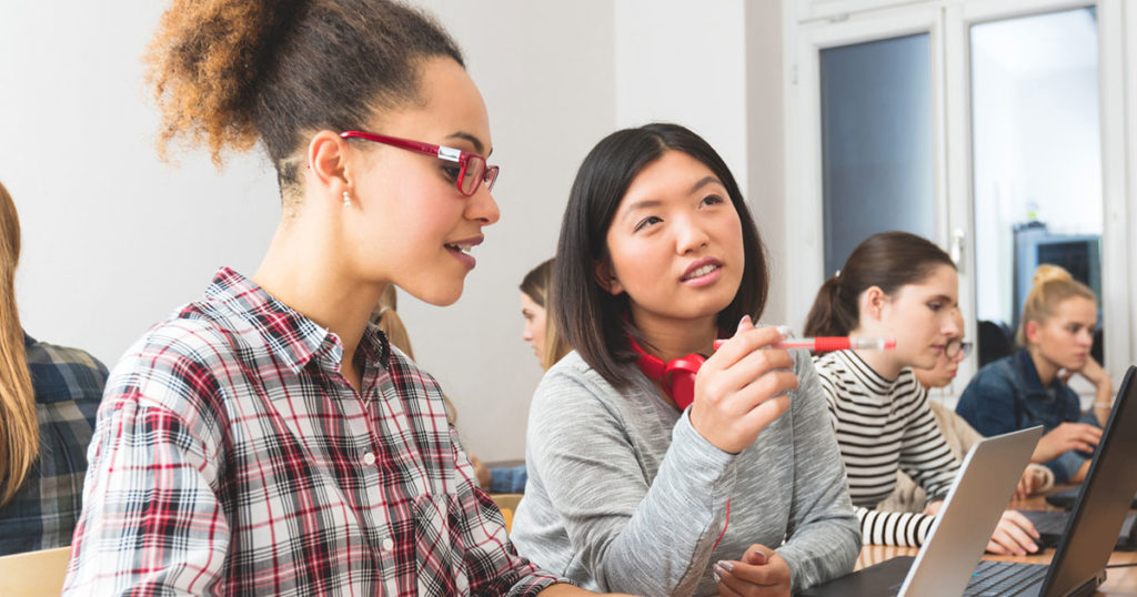 Two girls working on a project together through pathways to prosperity