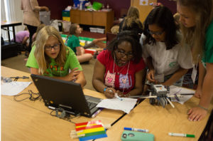 Girls learn how to assemble and code Lego robots during IBM day of E.X.I.T.E. camp.