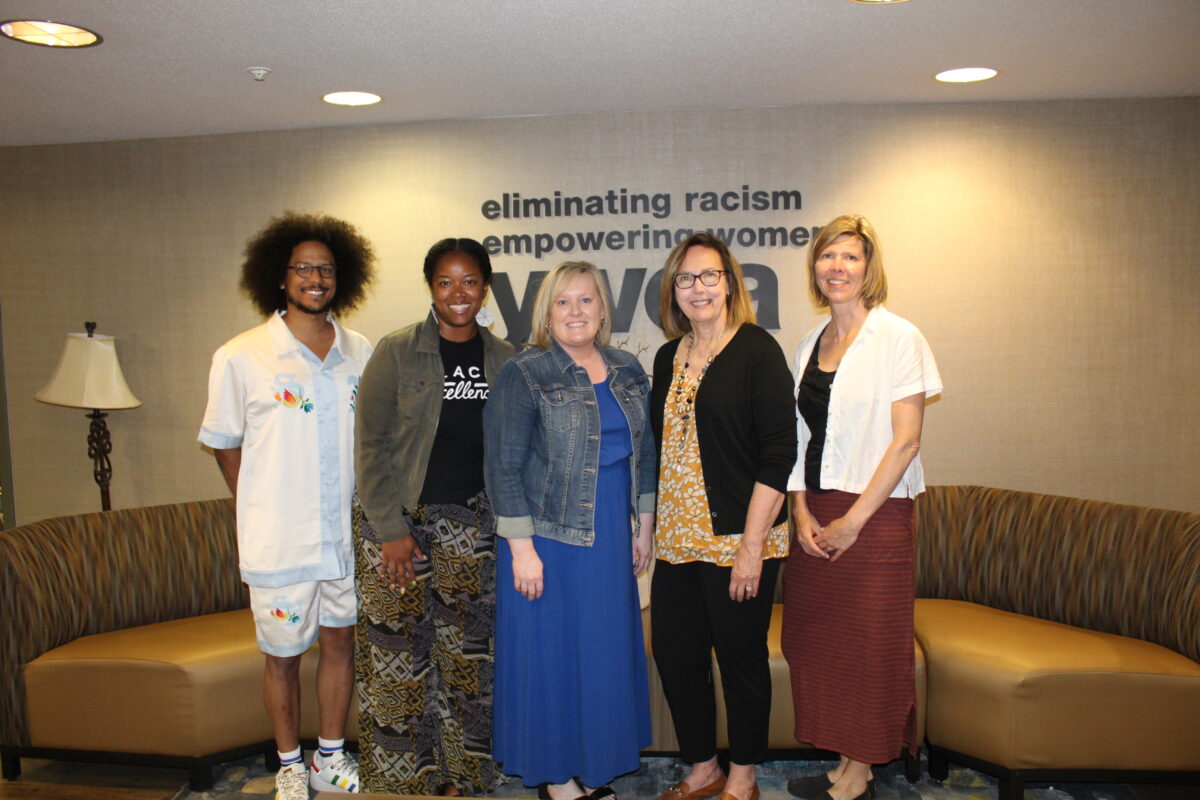 WFM staff and YWCA staff standing and smiling together