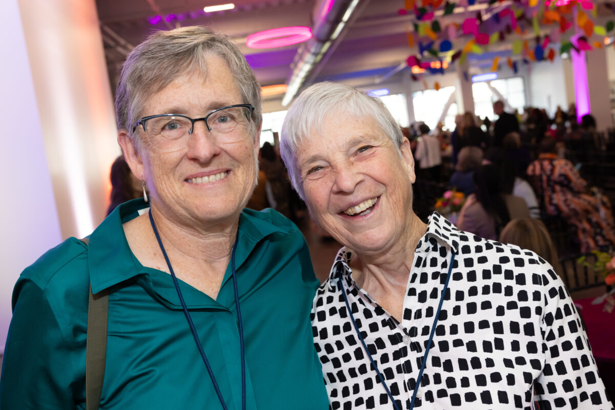couple with short hair smiling at camera