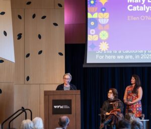 Ellen O'Neill speaking from podium