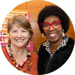 Two women looking at camera, smiling